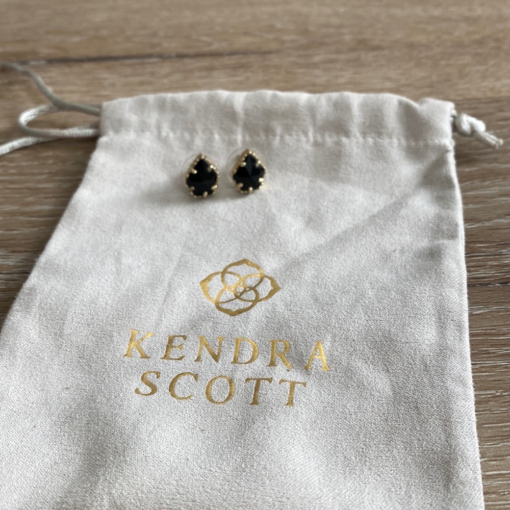 Kendra Scott black and gold earrings.
